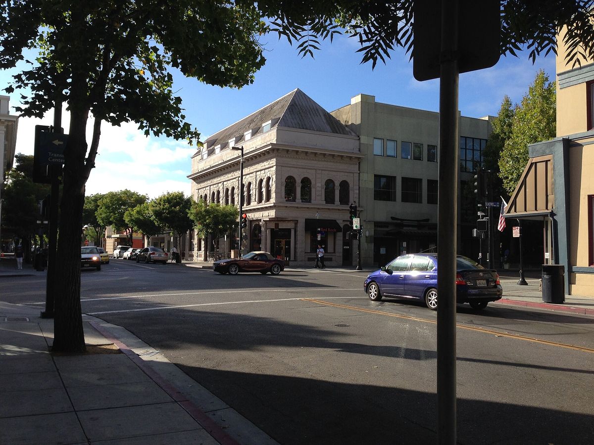 The corner of Castro and Villa Streets, with an old stone building at its center